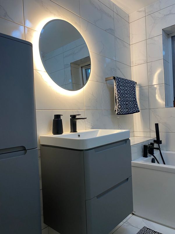 Bathroom sink installation black, grey and white with luminous mirror
